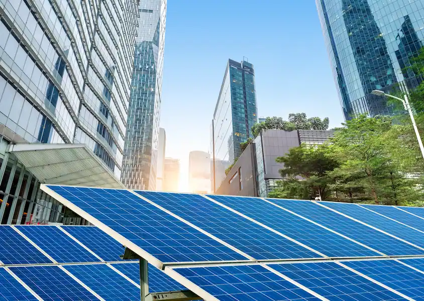 solar panels with city in background